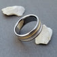 Handcrafted titanium ring with two concave Inlays of solid 18k gold and sterling silver