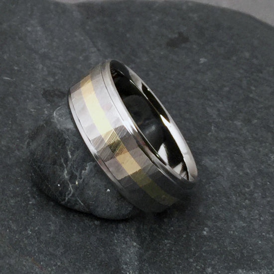 Beautifully handcrafted titanium wedding band from Classic Titanium. Inlaid with one centered 18k gold stripe. Faceted with our original "Wood Grain Sequoia" finish.