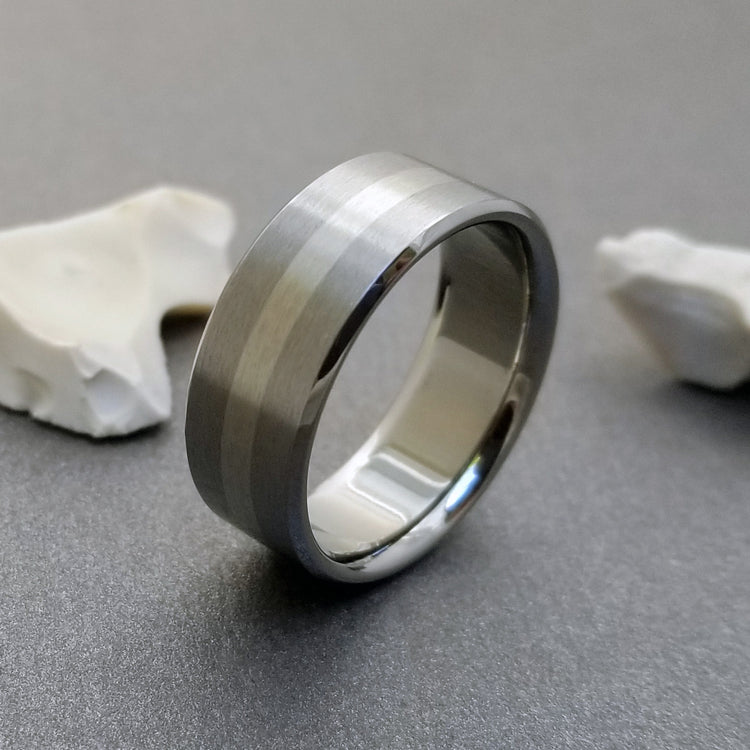 Handmade titanium wedding band, inlaid with one stripe of solid 18k white gold.